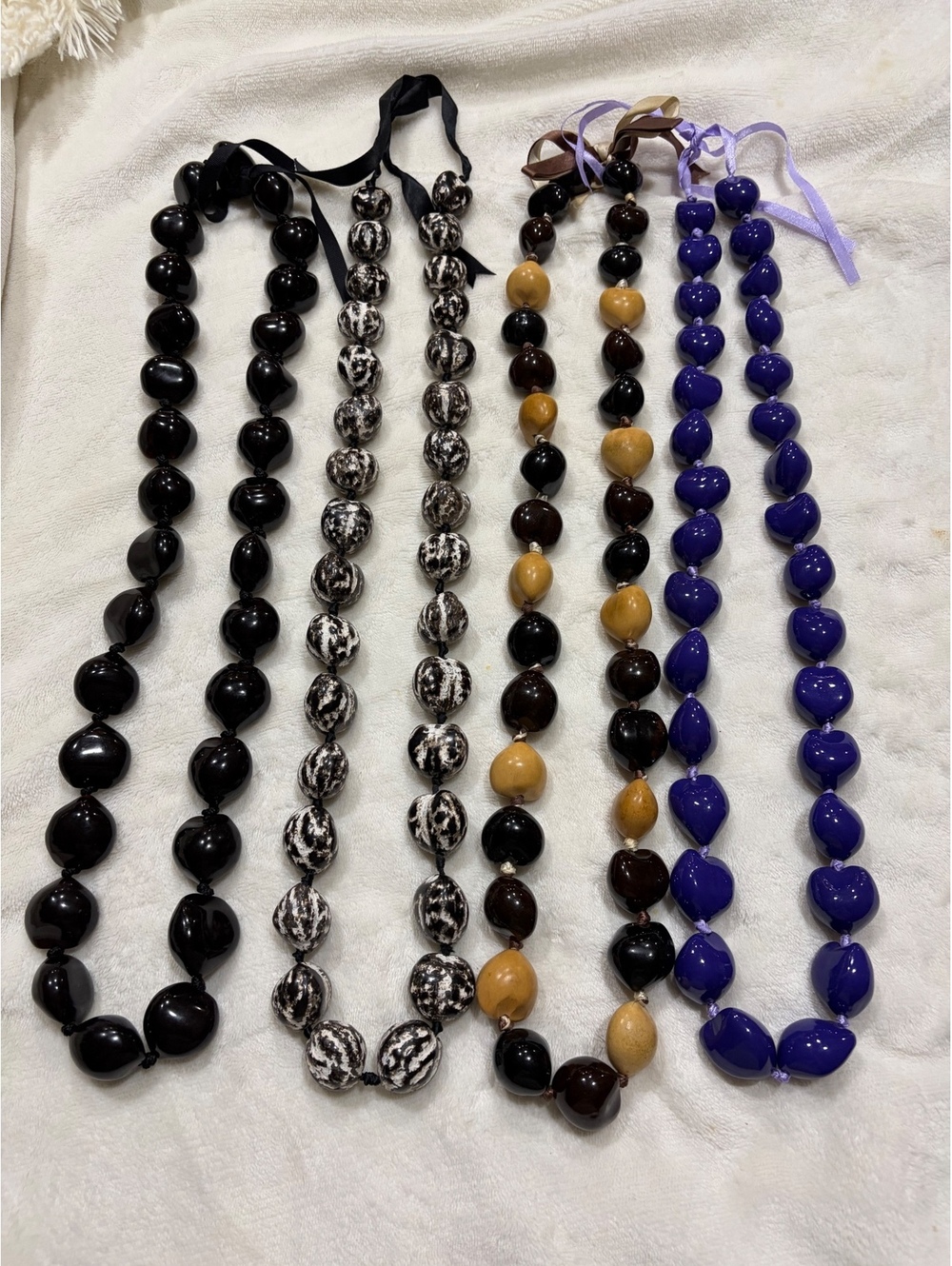 Set of 4 handcrafted Hawaiian kukui nut leis black, purple, black / white multi